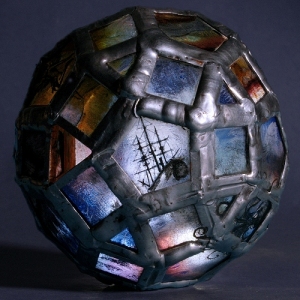 The ‘Storm Troubled Sphere’ a 75mm diameter bead made from 60 pieces of glass, hand painted with kiln fired enamel.